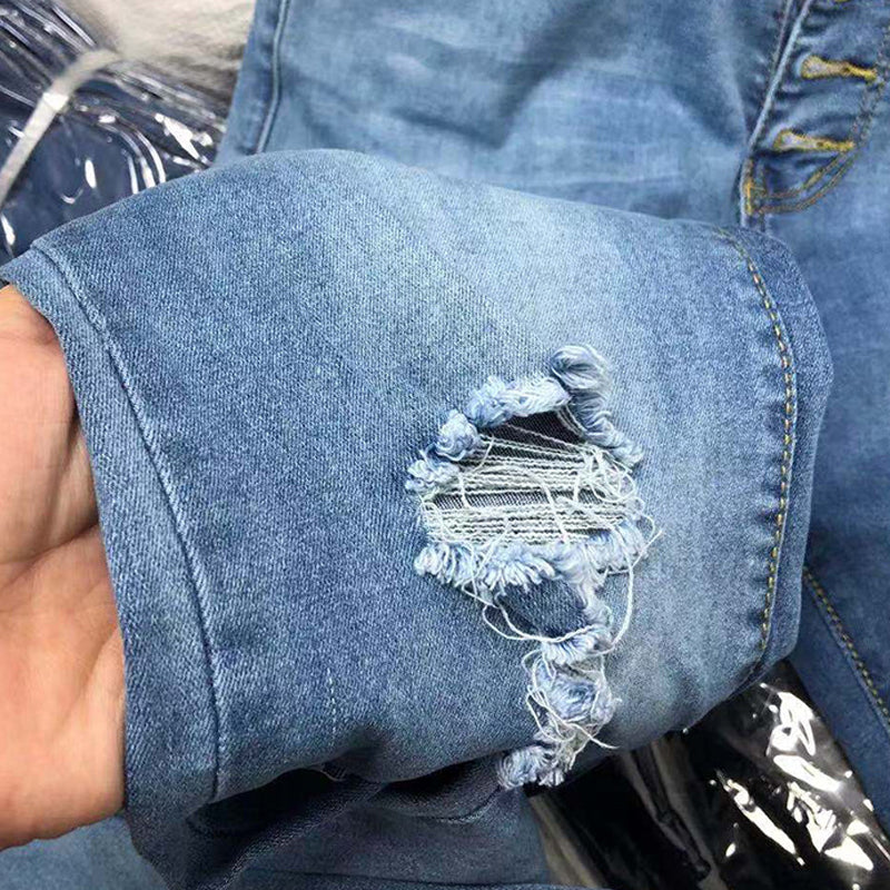 Femknäppta slitna jeans